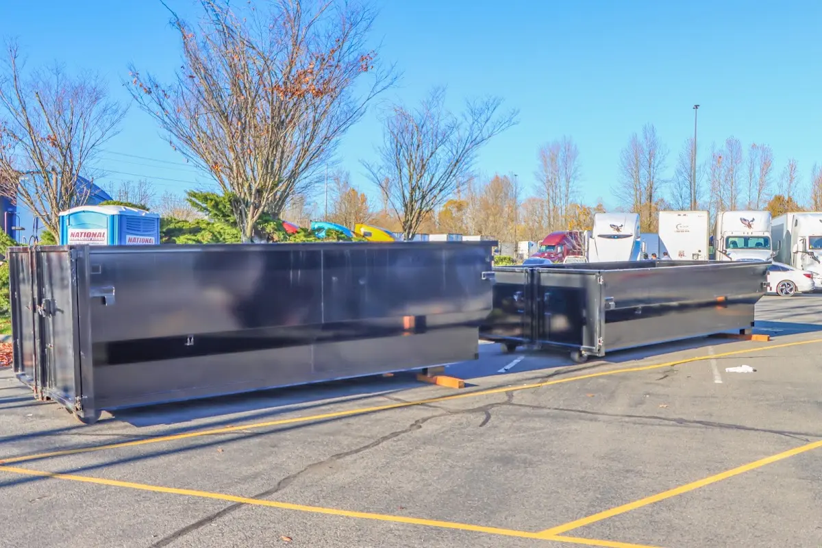 Professional dumpster rental service with roll-off container on residential driveway in New Port Richey